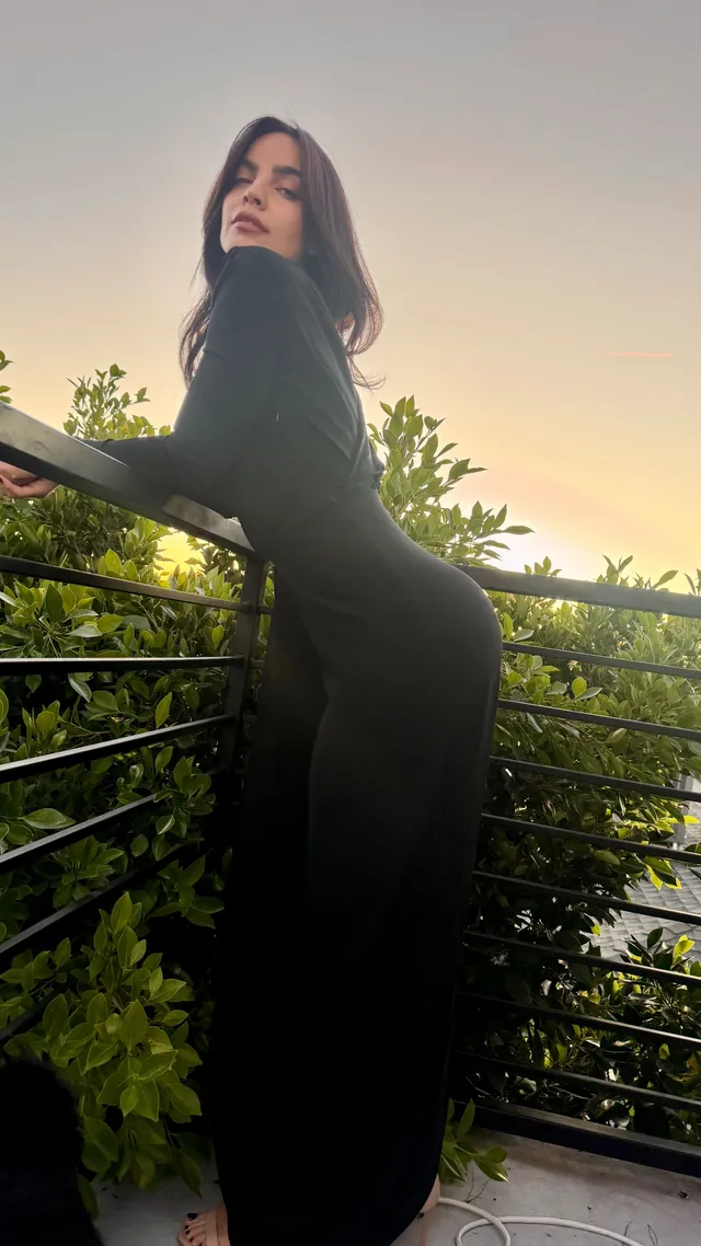 María Gabriela de Faría posing on a balcony in a black dress.