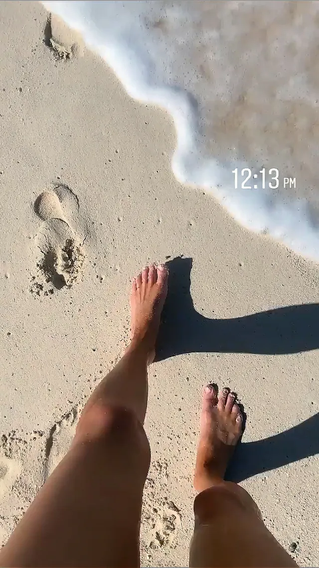 Kate Bosworth standing at the edge of shallow water.