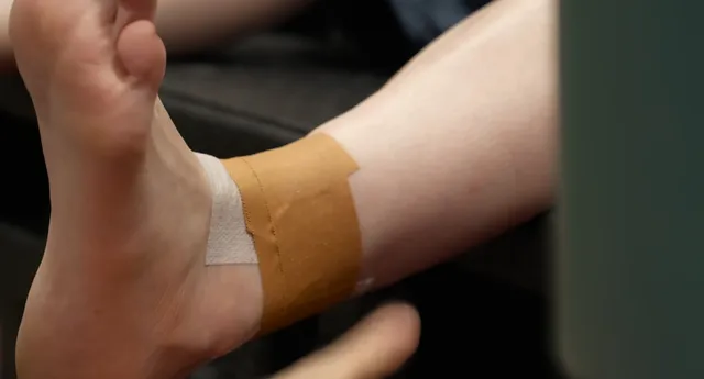 Billie Eilish a close-up of a taped ankle and bare sole.