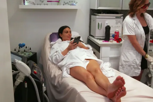 Kim Kardashian: reclining barefoot on a treatment chair.