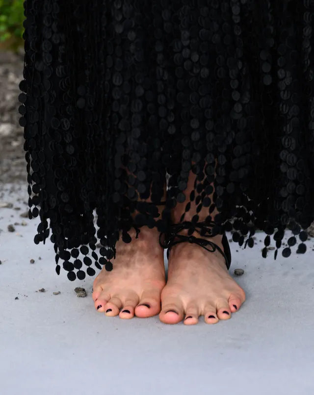 Margaret Qualley a front view of black lace up heels.