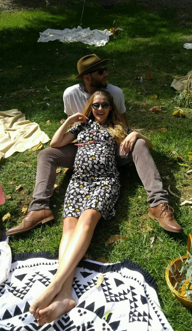 Teresa Palmer relaxing with a companion on a picnic blanket.