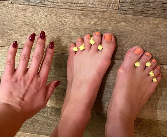 Florence Pugh a close detail of bare feet and painted toenails.