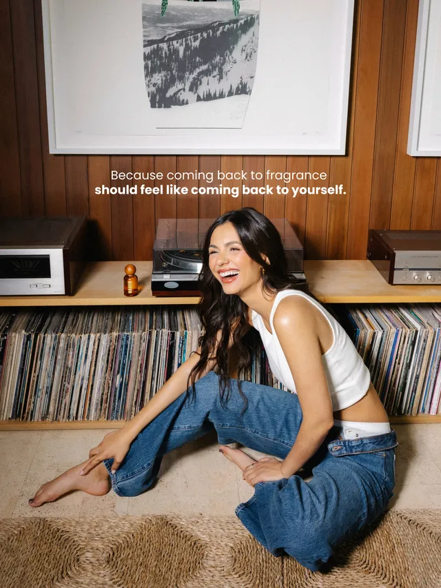 Victoria Justice sitting barefoot beside a record collection.