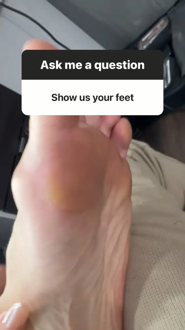Heidi Klum raising her bare sole while seated in a cabin.