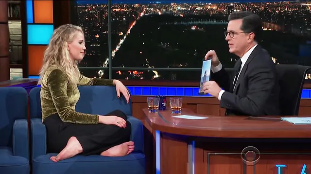Jennifer Lawrence sitting barefoot during a television interview.