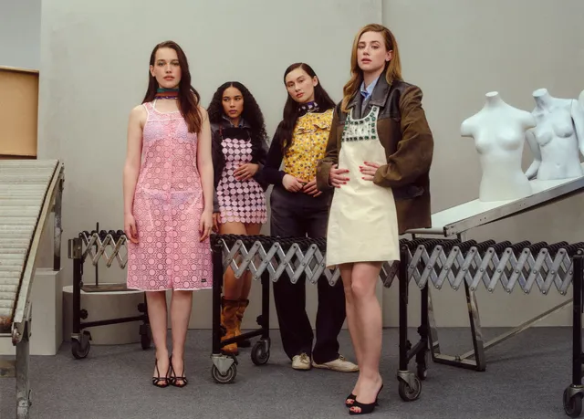 Victoria Pedretti posing with companions during a fashion shoot.