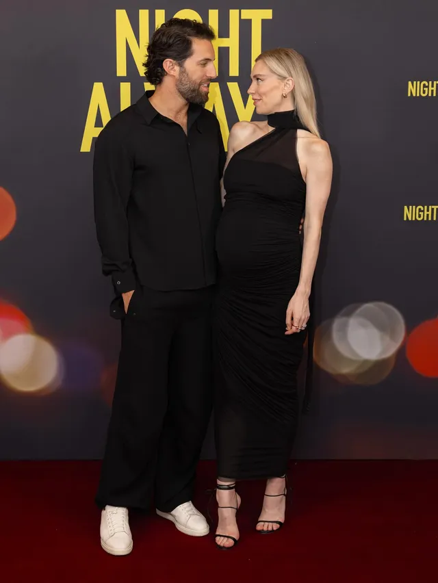 Vanessa Kirby standing at a premiere beside a companion.