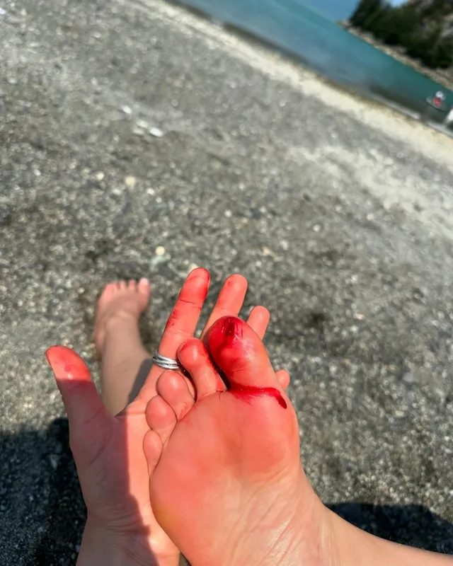 Sophie Nélisse showing her bare feet outdoors beside the sea.