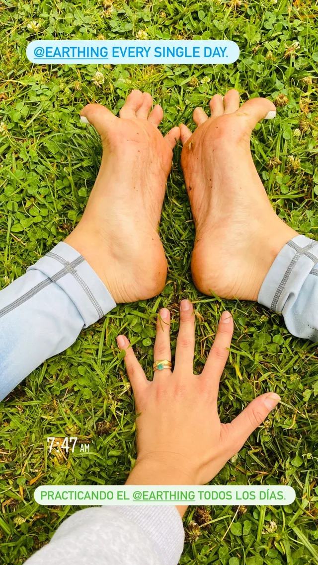 María Gabriela de Faría standing barefoot on grass.