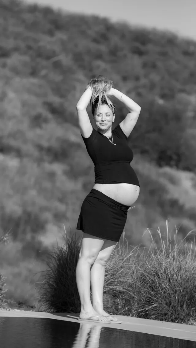 Kaley Cuoco standing barefoot in a monochrome portrait.