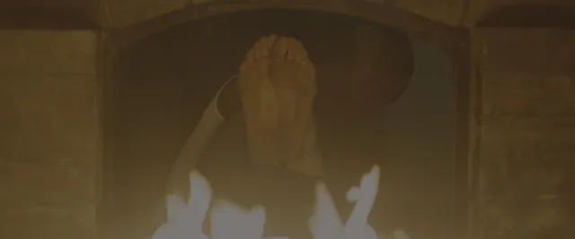 Margaret Qualley a dimly lit screen detail of bare soles.