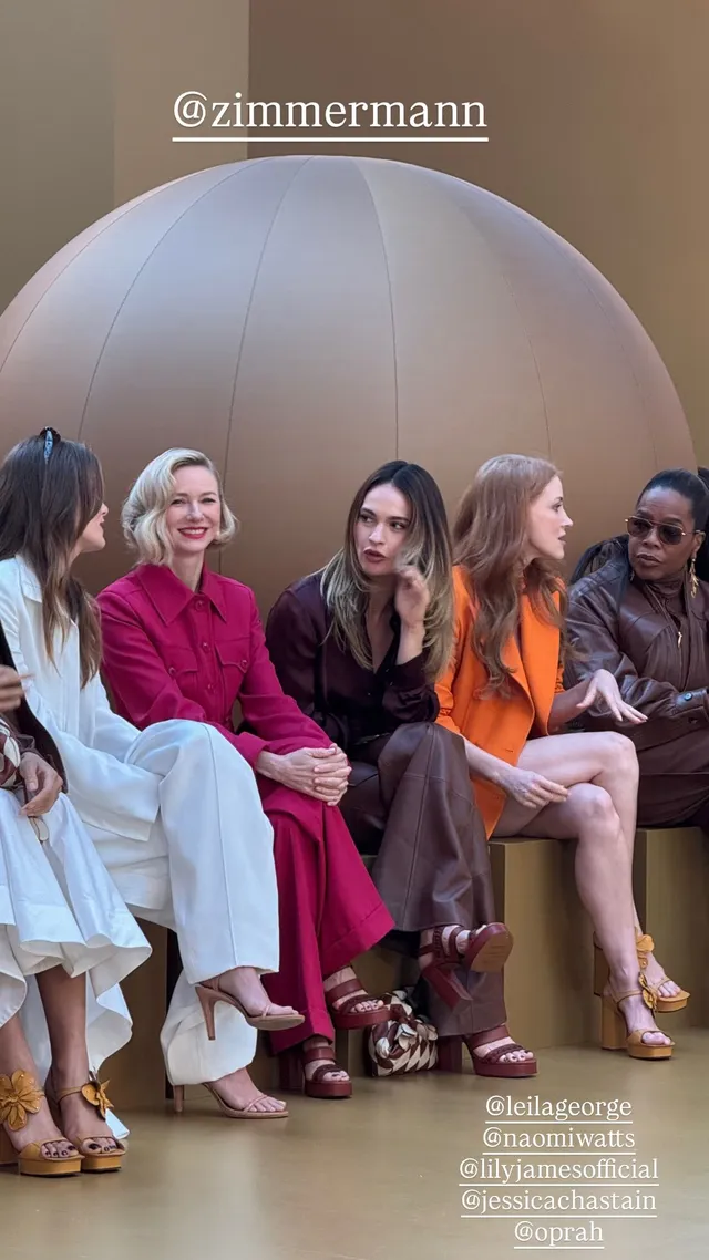 Jessica Chastain sitting among guests at a fashion show.