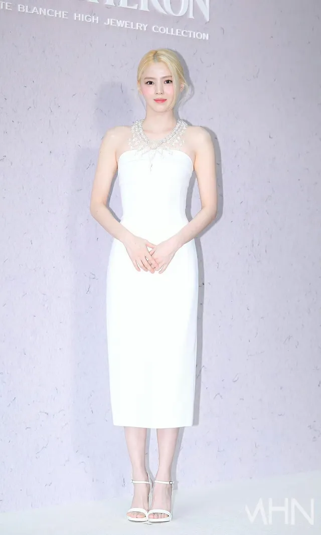 Han So-hee posing in a white dress and heels.