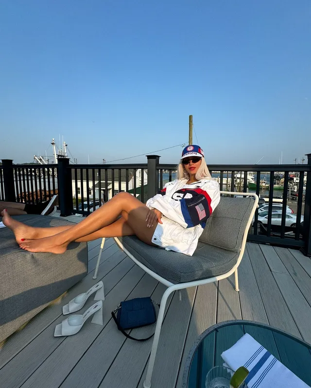 Beyoncé relaxing barefoot in a chair on a boat.