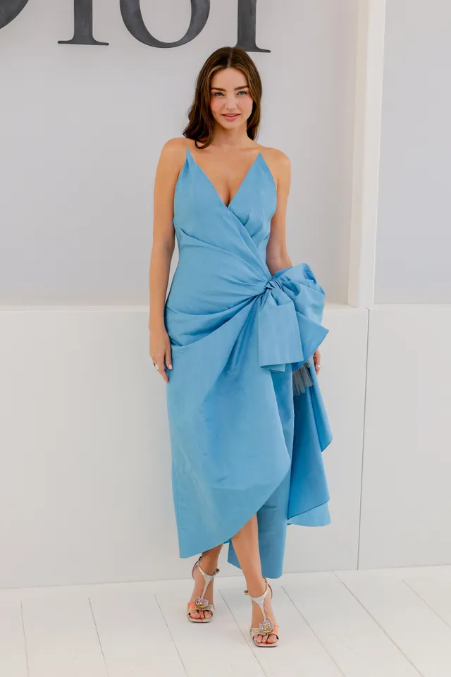 Miranda Kerr a blue dress with pale heels at a fashion event.