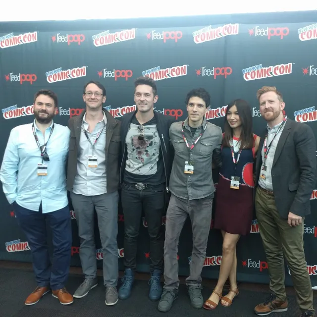 Gemma Chan posing with other guests at a convention.
