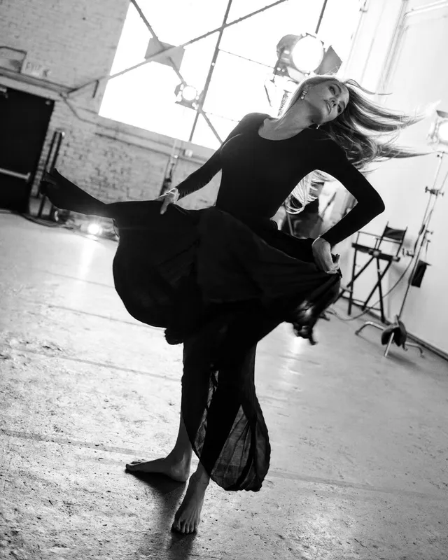 Angelina Jolie a monochrome studio portrait in a flowing black dress.