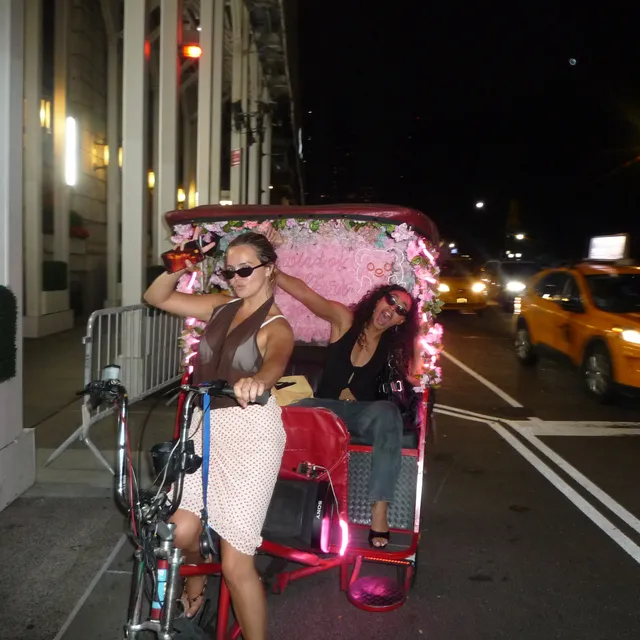 Bailee Madison wearing white heels beside a rickshaw.