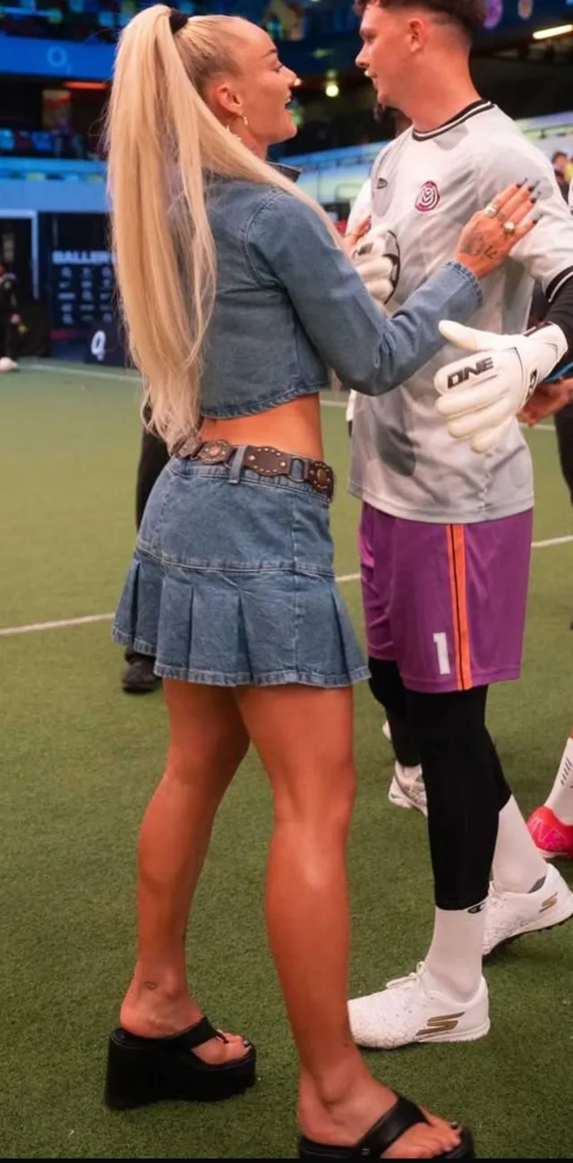 Alisha Lehmann standing beside a companion in black platform heels and a denim skirt.