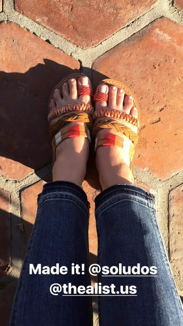 Adelaide Kane a close-up of colorful espadrille shoes.