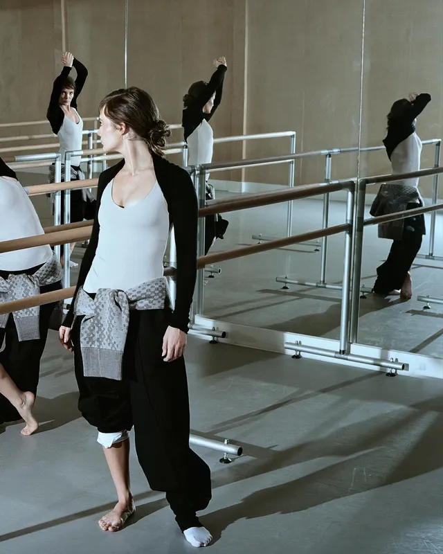Freya Allan wearing dance clothes and a white sock in a rehearsal studio.
