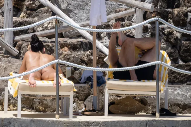 Dua Lipa: relaxing barefoot on a seaside sun lounger.