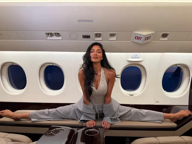 Nicole Scherzinger stretching barefoot across a table inside an aircraft.