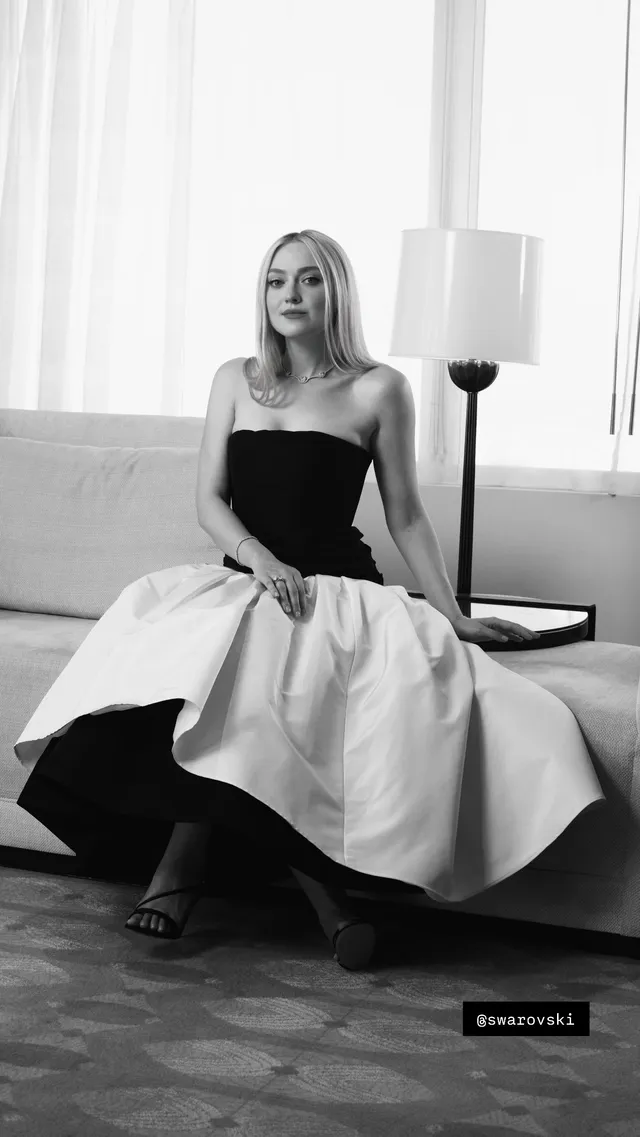 Dakota Fanning sitting in a black and white dress for a monochrome portrait.