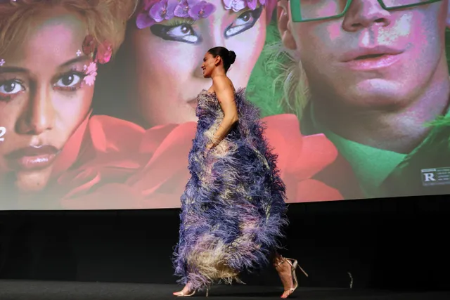 Eiza González walking in a purple textured gown and heels at a premiere.
