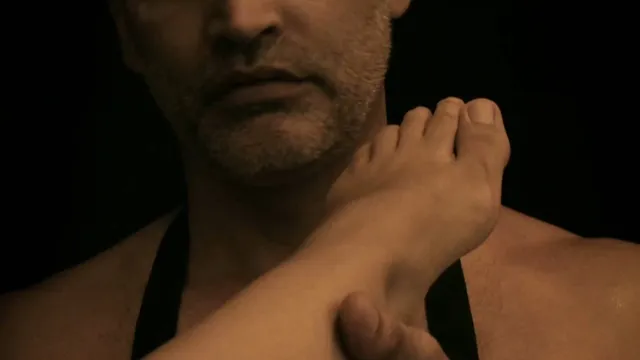 Ana de Armas resting her foot near a companion's shoulder in a film close-up.