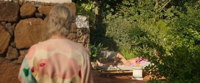 Olivia Cooke standing in a garden in a screen scene.