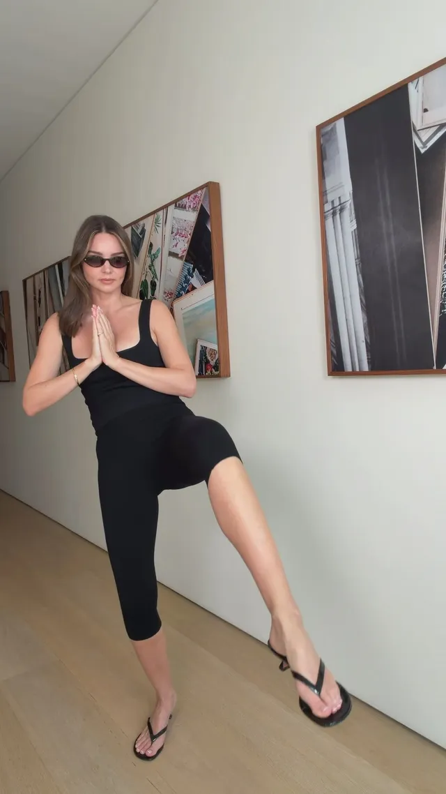 Miranda Kerr a raised flip-flop during an indoor pose.