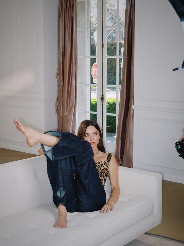 Miranda Kerr a relaxed portrait on a white sofa.