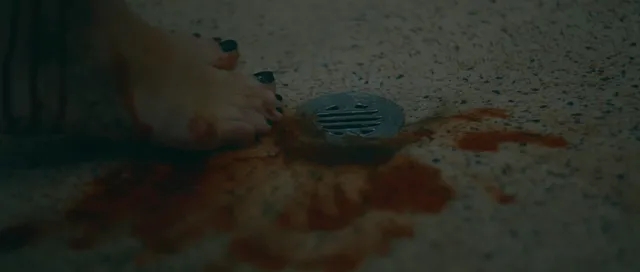 Olivia Holt shown in a close-up of a bare foot in a scene.