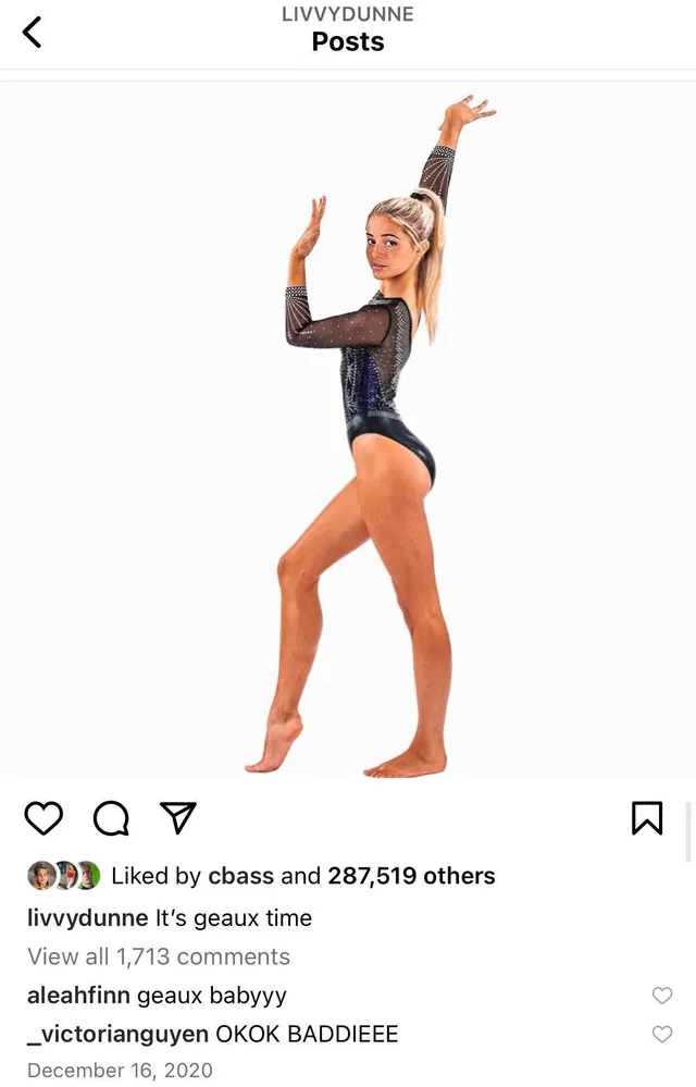 Olivia Dunne posing in a black gymnastics leotard.