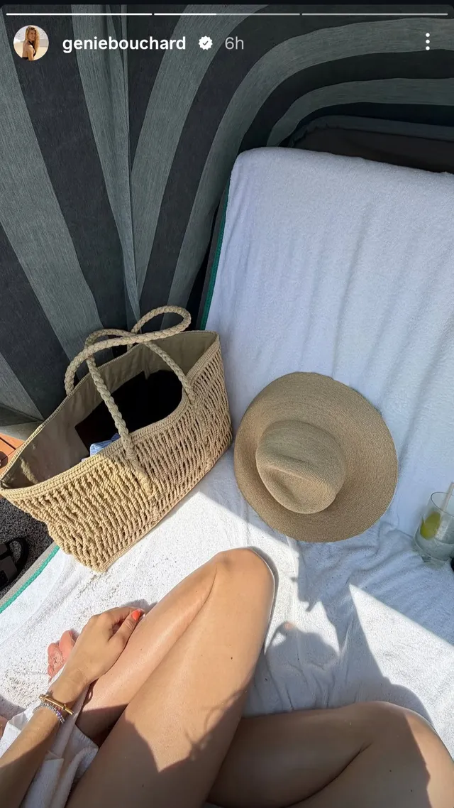 Eugenie Bouchard wearing flat sandals while seated on an outdoor lounger.