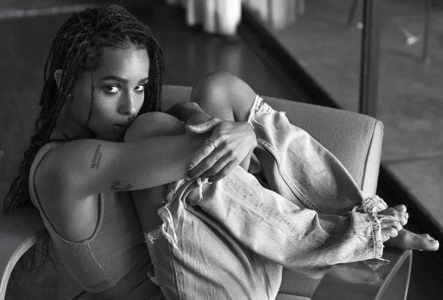 Zoë Kravitz sitting in a monochrome fashion portrait.