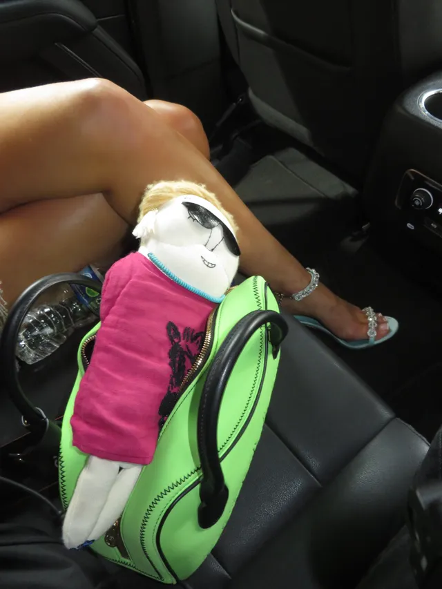 Zara Larsson showing heeled sandals while sitting in a car.