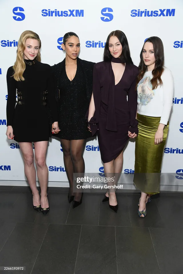 Victoria Pedretti posing with companions at a radio event.