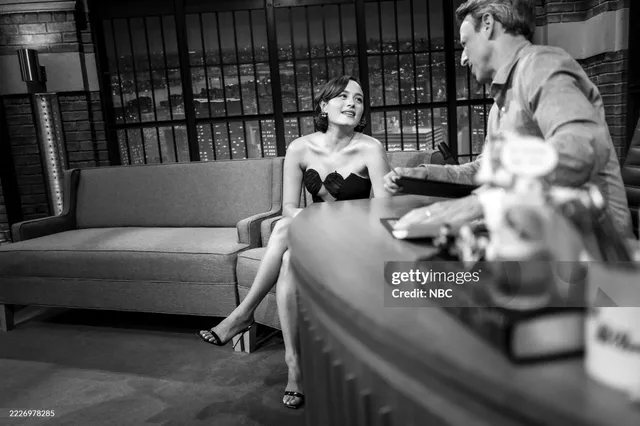 Chase Sui Wonders sitting in black heels during a monochrome television interview.