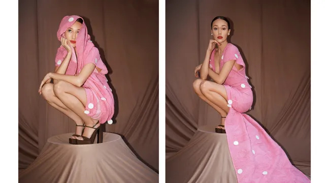 Alycia Debnam-Carey crouching for a fashion portrait in a pink dress.