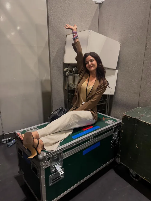 Danielle Campbell sitting on a backstage equipment case.
