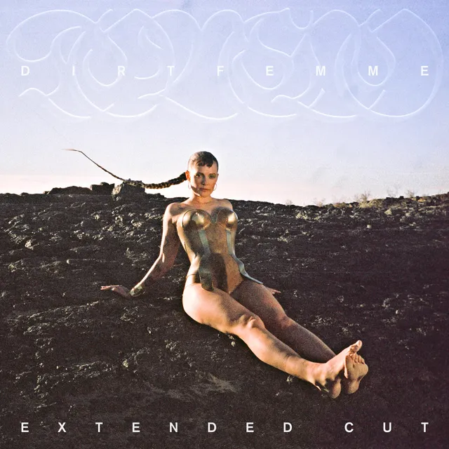 Tove Lo sitting barefoot outdoors in a printed promotional photograph.