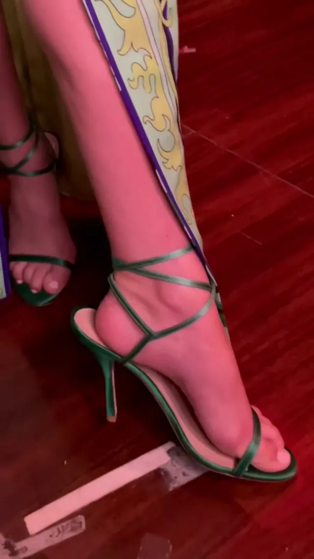 Bailee Madison wearing green lace-up heels.