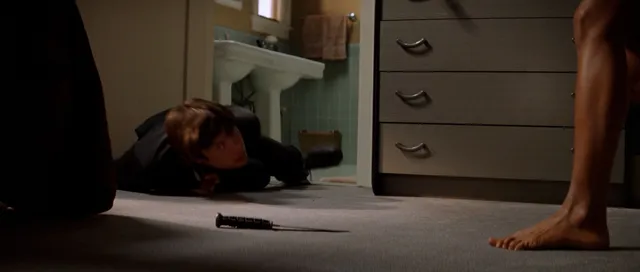 Rachel McAdams showing a bare foot near a doorway in a film scene.