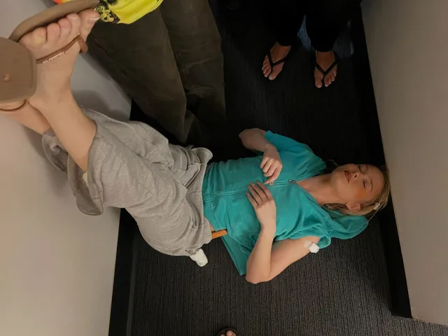 Zara Larsson reclining aboard an aircraft with bare feet raised.