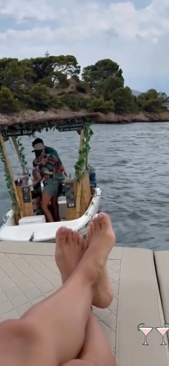 Eva Longoria relaxing on a boat with her legs crossed.
