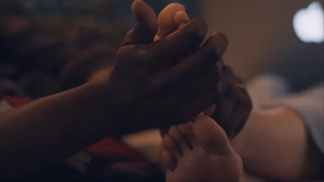 Elizabeth Olsen showing a bare sole in a dimly lit screen scene.