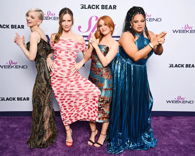 Isla Fisher standing with cast members at a film event.